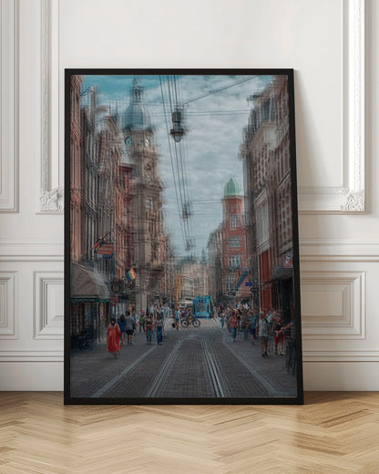 A motion-blurred, dreamlike photograph of a busy street in Amsterdam. Historic buildings line the cobblestone road, which is filled with pedestrians and features tram tracks. A prominent clock tower rises against a cloudy blue sky, and the entire scene has a shaky, layered effect. Poster