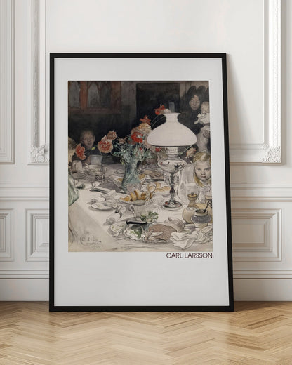 A classic watercolor painting by Carl Larsson from 1900, showing a family enjoying a festive meal around a dining table. A large white lamp illuminates the scene, highlighting the cluttered table with dishes, food, and a vase of red flowers. Several children and adults, including a woman holding a baby, are seated at the table in a warm, domestic setting. Decor