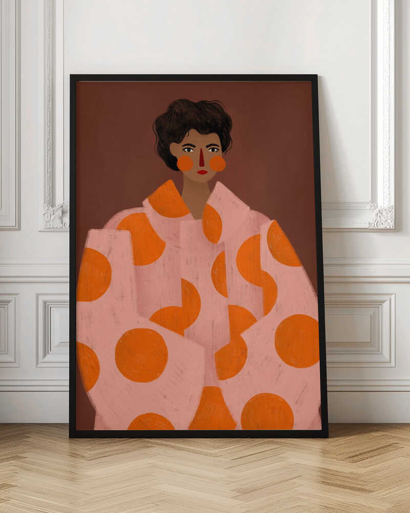A stylized portrait illustration of a person with dark curly hair and warm brown skin against a solid reddish-brown background. They wear a light pink, oversized coat with large orange polka dots, and look directly forward with a neutral expression, accented by red lipstick and circular orange blush. Decor