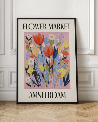 A vintage-style poster for the 'FLOWER MARKET AMSTERDAM'. The artwork features a vibrant illustration of various stylized flowers, including red tulips, white daisies, and yellow and blue foliage, set against a solid pink background. The text is in a black serif font, with 'FLOWER MARKET' at the top and 'AMSTERDAM' at the bottom, all enclosed by a cream-colored border and a simple black frame. Poster