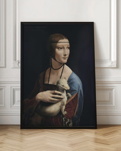 A classic portrait painting by Leonardo da Vinci, 'Lady with an Ermine,' in a thin black frame. The painting shows a woman in Renaissance attire with her hair pulled back, holding a white ermine against a dark, plain background. She is turned three-quarters and looks off to the side. Artwork