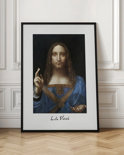 A framed print of Leonardo da Vinci's painting 'Salvator Mundi', depicting Jesus Christ in a blue robe against a black background. He holds a crystal orb in one hand and gives a blessing with the other. The artist's name is written below the image. Artwork