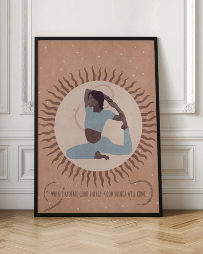 An illustration of a woman in a light blue outfit holding a King Pigeon yoga pose. She is centered within a large, pale circle representing the sun, which has wavy brown rays. The background is a dusty rose color with white specks, and a quote at the bottom reads, 'When I radiate good energy, good things will come.' Decor