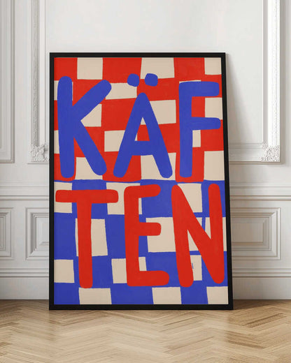 A bold graphic art print featuring the word 'KÄFTEN' split into two lines against a checkerboard background. The top line 'KÄF' is in blue text over a red and cream checker pattern. The bottom line 'TEN' is in red text over a blue and cream checker pattern. The style is playful and hand-painted, enclosed in a thin black frame. Wall Art