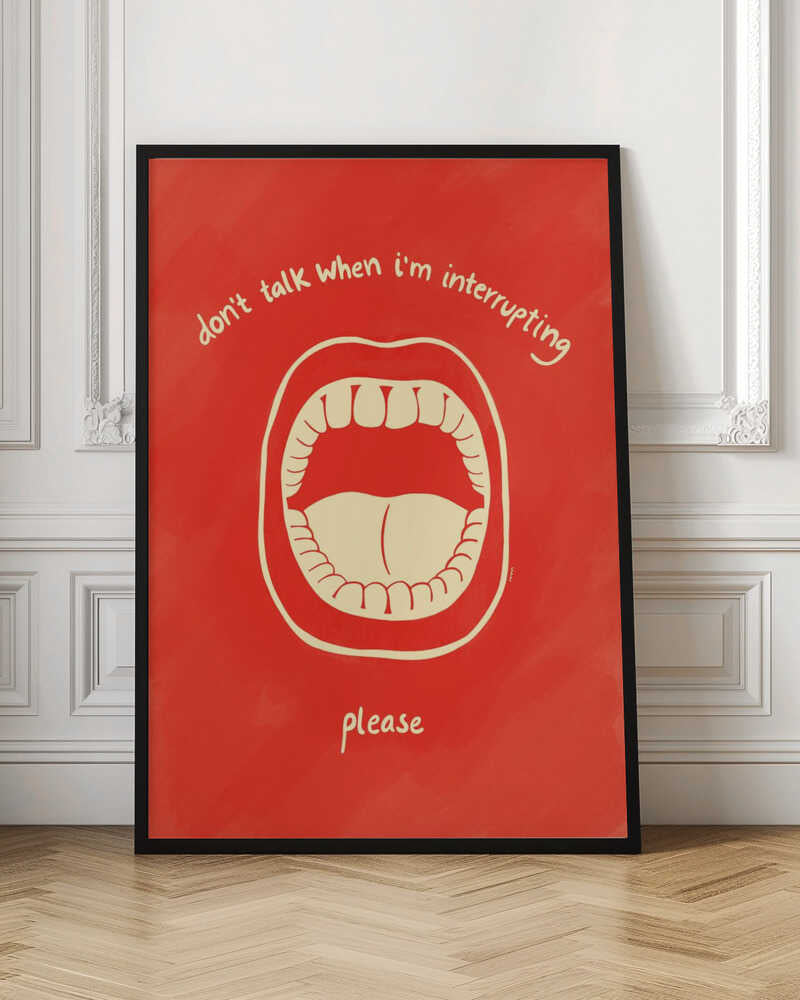 A humorous framed poster with a red background featuring a cream-colored line drawing of a large, open mouth. Above the mouth, the text reads 'don't talk when i'm interrupting' in an arch, and below it says 'please'. Print