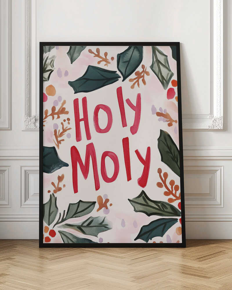 A watercolor-style Christmas-themed artwork with the phrase 'Holy Moly' hand-painted in bold red letters in the center. The text is framed by a loose arrangement of dark green holly leaves, red and orange berries, and small brown sprigs against a light cream and pink background. The artwork is shown in a thin black frame. Artwork