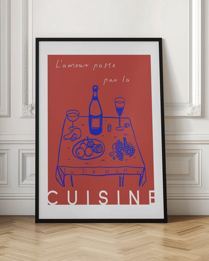 A vintage-style poster with a red background featuring a blue line drawing of a dinner table set with wine and fruit. Above the image is the French phrase 'L'amour passe par la' in white cursive script, and below is the word 'CUISINE' in a bold white font, completing the saying 'Love passes through the kitchen'. Wall Art