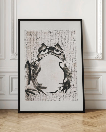 A traditional Japanese sumi-e ink wash painting of a large frog with a grumpy expression. The frog is rendered in bold black brushstrokes against an off-white paper background filled with Japanese calligraphy. The artwork is enclosed in a simple black frame. Poster