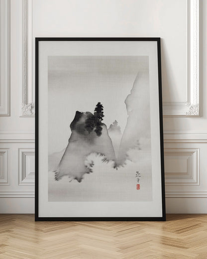 A traditional Asian ink wash painting in a black frame. The vertical artwork depicts a minimalist mountain landscape in black and grey tones on textured paper. A dark, prominent rock formation with a lone pine tree stands in the foreground, surrounded by mist, with fainter mountains in the background. A signature and a red seal are visible in the lower right corner. Artwork