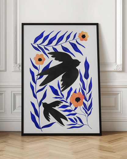 A graphic art print featuring two black bird silhouettes flying amidst stylized branches with bold cobalt blue leaves and three orange-peach flowers against a white background. Decor