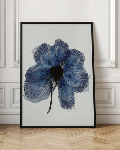 A framed modern illustration of a single large blue flower on a white background. The flower's petals are rendered with a combination of light blue watercolor wash and fine, radiating dark blue lines, creating a sense of texture. The center of the flower is a solid black mass, with smaller black shapes scattered across the petals, and it has a thin black stem. Wall Art