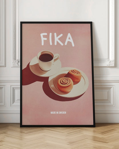 A poster with a pink background featuring the word 'FIKA' in white at the top. Below the text is a cup of black coffee and two cinnamon buns on white plates, with strong shadows. At the bottom, it reads 'MADE IN SWEDEN'. Poster