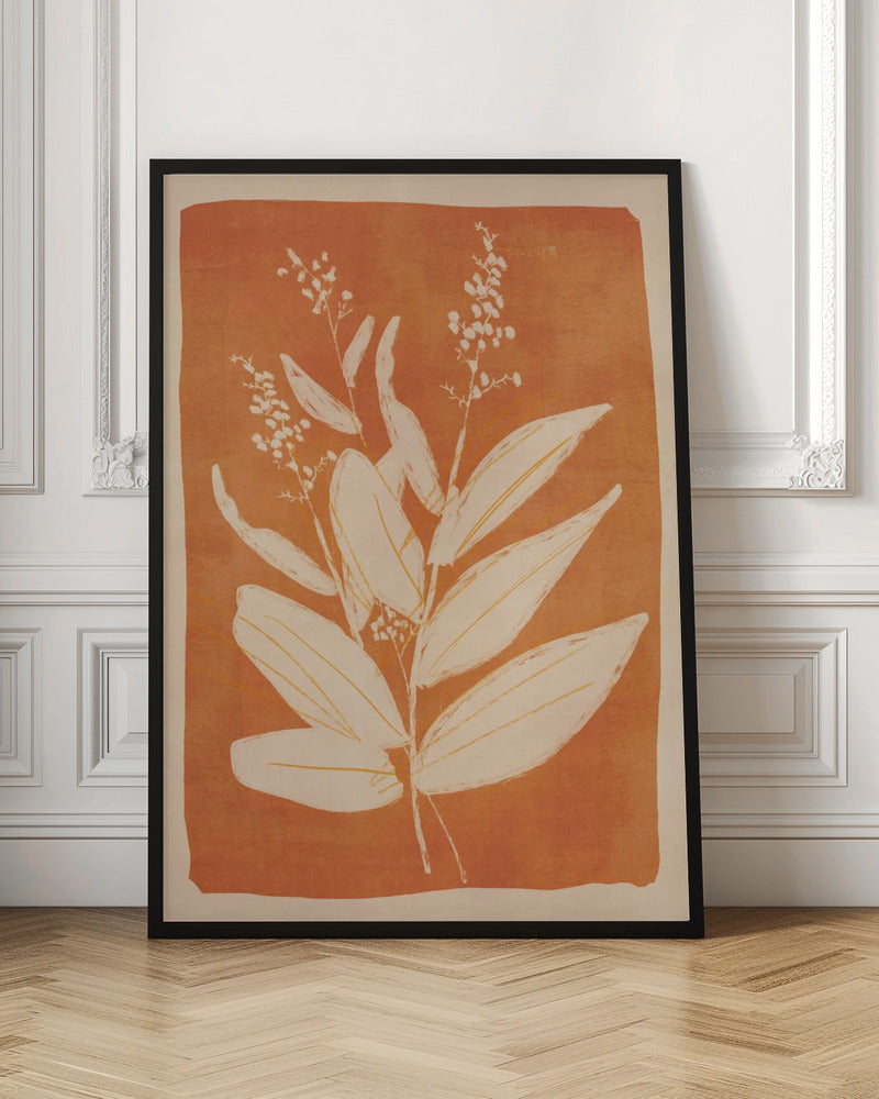 A botanical block print style illustration of a plant with large, pointed leaves and delicate flowering sprigs. The plant is rendered in a creamy off-white against a textured, burnt orange background. The artwork is presented in a simple black frame. Print