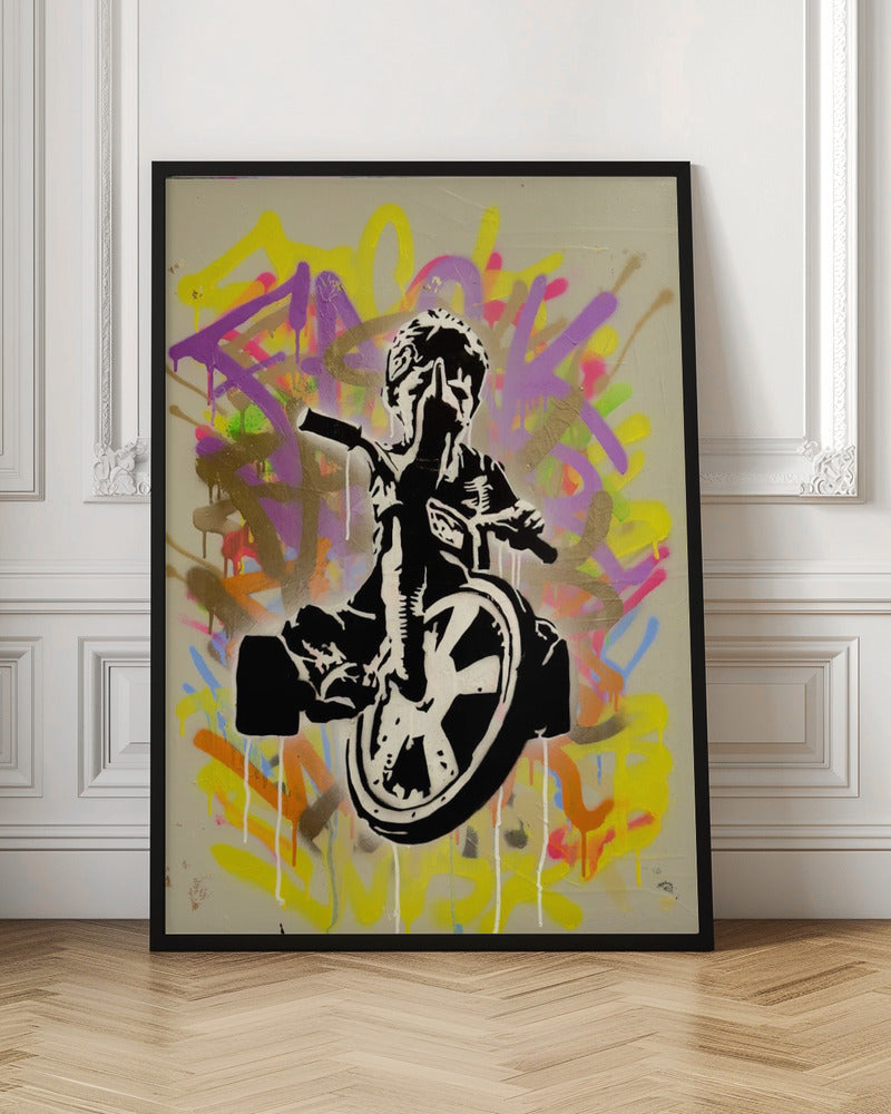 A framed street art piece featuring a black and white stencil of a rebellious child on a tricycle giving the middle finger, set against a vibrant, multi-colored graffiti background with paint drips. Artwork