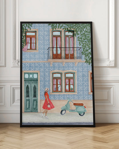 A watercolor illustration of a woman in a red dress and sun hat walking past a building with a blue and white patterned tile facade. A light green scooter is parked on the sidewalk, and the building features wooden windows with pink curtains, a teal door, and a second-story balcony. Print