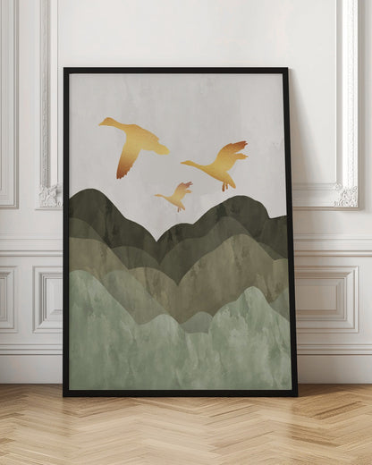 A minimalist art print of three golden bird silhouettes flying over a stylized landscape of layered mountains in muted shades of green and brown, set against a light grey, textured sky and enclosed in a thin black frame. Print