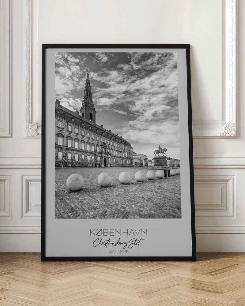 A black and white travel poster of Christiansborg Palace in Copenhagen, Denmark. The image shows the grand building and its tower against a dramatic cloudy sky, with a cobblestone square, stone bollards, and an equestrian statue in the foreground. Text at the bottom identifies the location. Decor