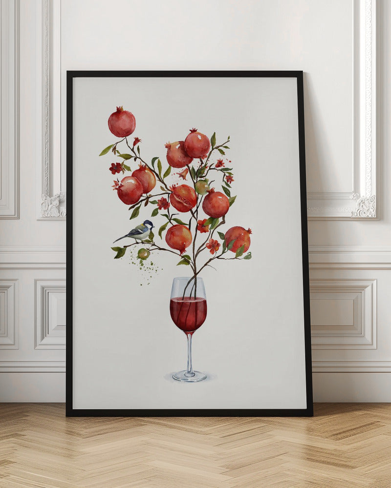 A surreal watercolor painting of a pomegranate branch growing out of a glass of red wine. The branch is laden with ripe red pomegranates, small red blossoms, and green leaves. A small blue and white bird is perched on a twig. The background is a clean, solid white, and the entire image is framed in black. Wall Art
