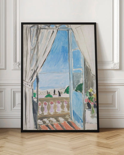 A Fauvist-style painting by Henri Matisse of a view from a window. The scene looks out from behind white curtains, over a balcony with a terracotta floor, to a bright blue sea and sky. Silhouettes of people walk along a promenade in the distance. To the right, a small vase of colorful flowers sits on a table. Decor
