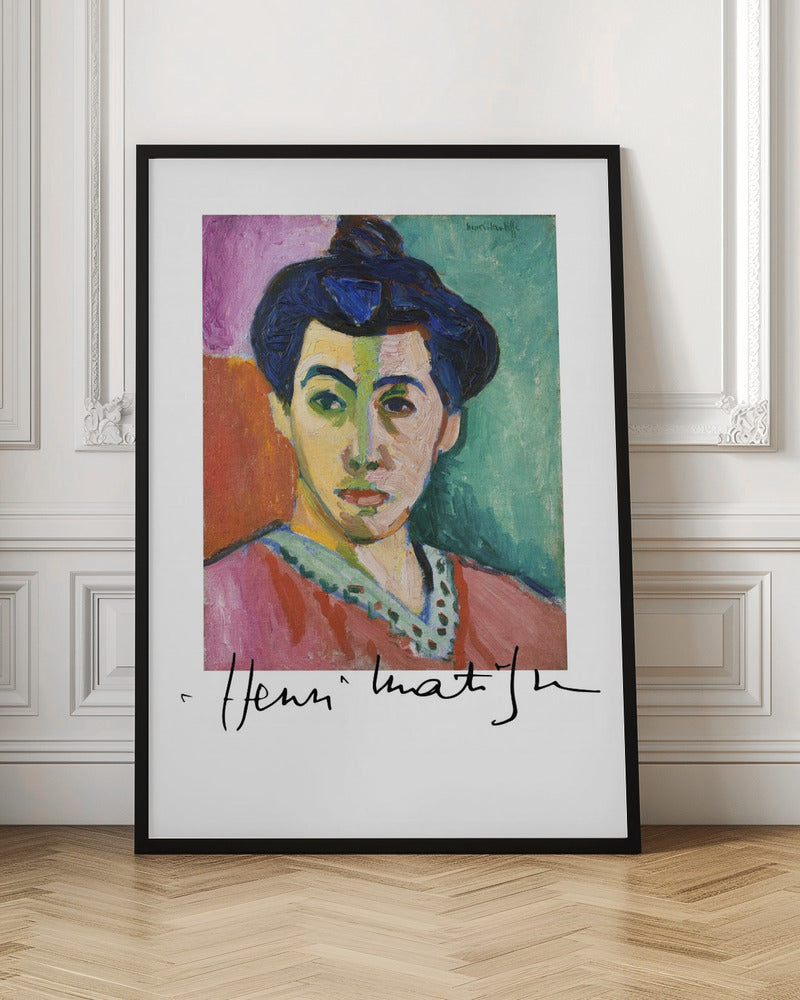 A framed art print of Henri Matisse's famous Fauvist painting, 'The Green Stripe (Portrait of Madame Matisse)'. The portrait features a woman with her hair up, her face divided by a vertical green stripe against a background of bold color blocks in purple, red, and green. The artist's signature is visible below the painting. Poster