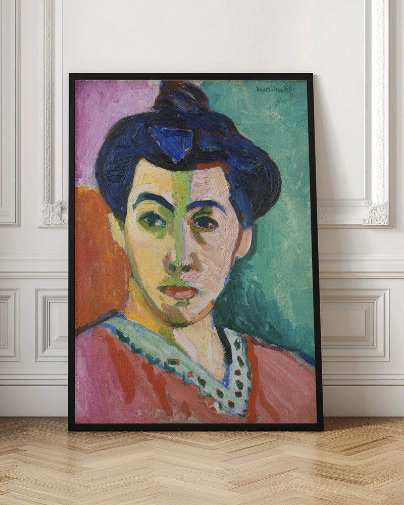 A Fauvist portrait painting by Henri Matisse, 'The Green Stripe,' featuring a woman with dark hair in an updo. Her face is strikingly rendered with unrealistic colors, bisected by a prominent green stripe. The background is composed of bold, flat planes of pink, orange, and teal. Print