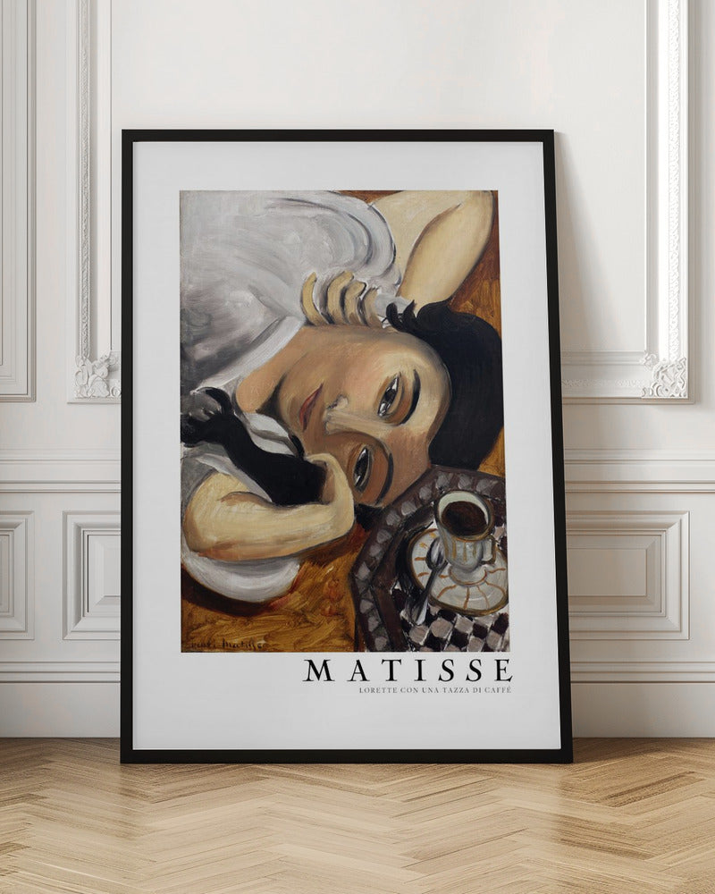 A framed art print of Henri Matisse's painting, 'Lorette con una tazza di caffè' (Lorette with a Cup of Coffee). The portrait features a woman with dark hair lying down, gazing directly at the viewer, with a cup of coffee on a checkered saucer beside her. The artist's name and the title are printed below the image. Decor