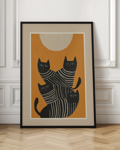 A framed art print of a stylized illustration featuring four black cats with white striped bodies stacked together. They are set against a solid orange background with a large, textured, cream-colored moon or sun at the top. Artwork