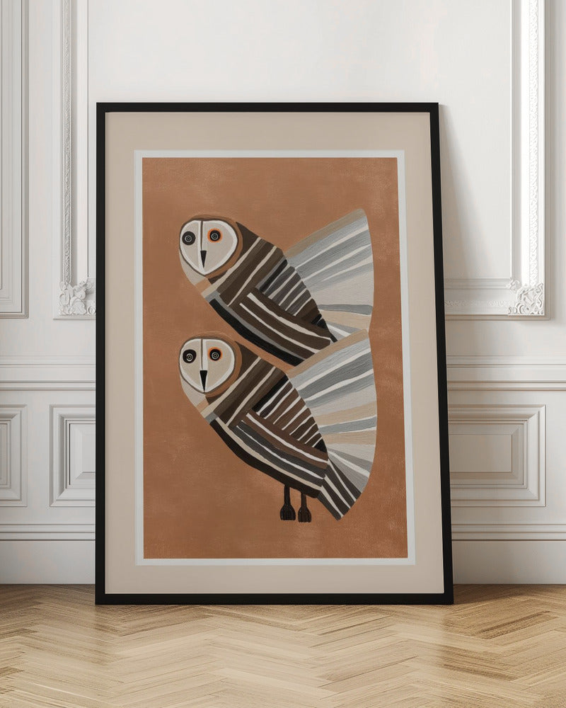 A framed modern art print of two stylized barn owls against a warm brown background. The owls are decorated with geometric stripes in shades of brown, beige, grey, and black, and have large, captivating eyes. Wall Art