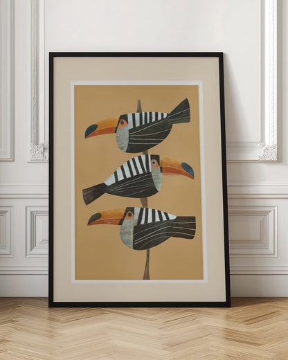 A framed graphic illustration of three stylized toucans perched one above the other on a thin vertical branch. The birds, facing left, have black bodies with bold white vertical stripes, and large, vibrant orange beaks. The background is a solid mustard yellow. Decor