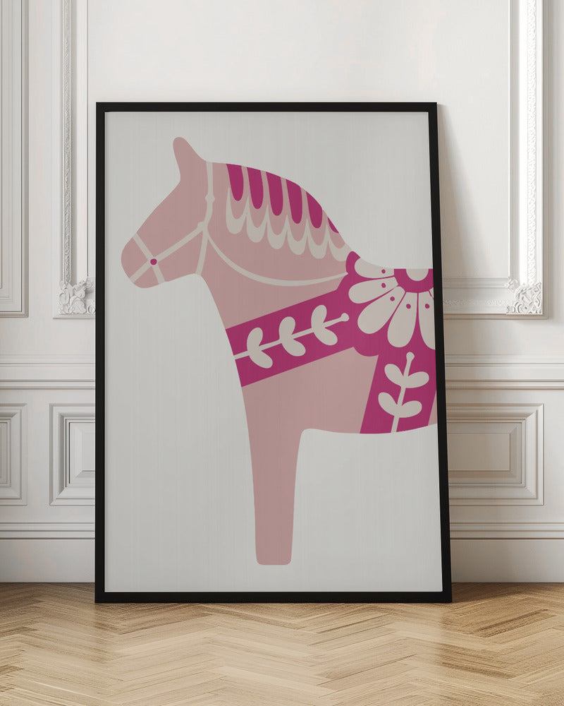 A framed art print featuring a stylized Scandinavian Dala horse in profile. The horse is various shades of pink and magenta with decorative off-white patterns on its mane, bridle, and saddle area, set against a light gray background. Decor