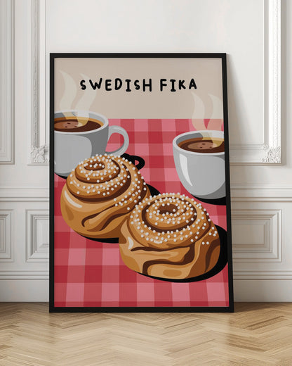 An illustration of a Swedish Fika poster featuring two large cinnamon buns topped with pearl sugar and two white cups of steaming hot coffee on a red and pink checkered tablecloth. The words 'SWEDISH FIKA' are written at the top. Artwork