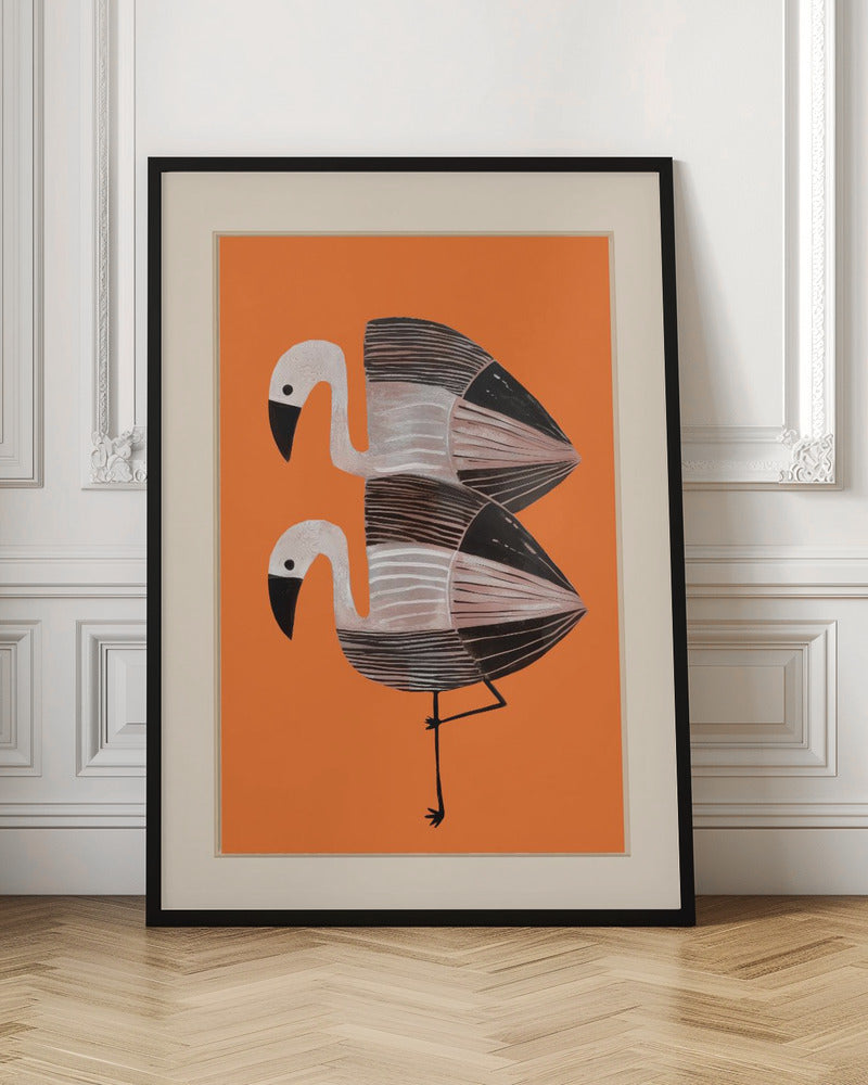 A framed art print of two stylized flamingos against a solid orange background. The birds are stacked vertically, with white heads, black beaks, and bodies featuring black, white, and grey stripes. The lower bird is standing on one leg. Wall Art