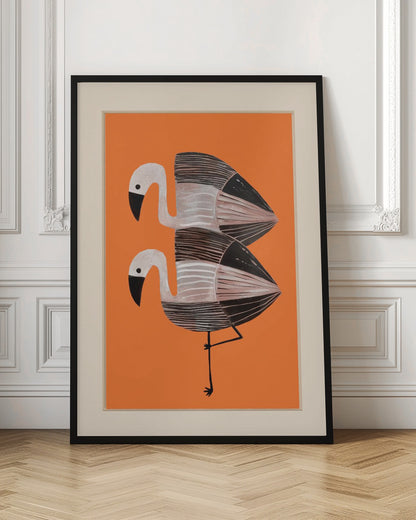 A framed art print of two stylized flamingos against a solid orange background. The birds are stacked vertically, with white heads, black beaks, and bodies featuring black, white, and grey stripes. The lower bird is standing on one leg. Wall Art