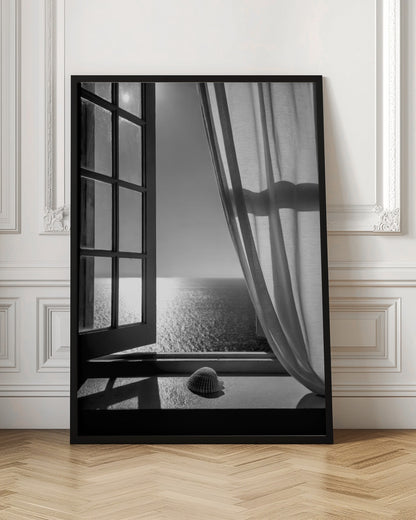 A serene black and white photograph looking out an open paned window at a sunlit ocean. A single seashell rests on the windowsill in the foreground, with shadows cast by the window frame. A light curtain hangs to the right, framing the tranquil sea view. Poster