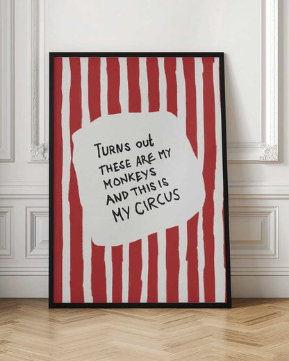 A framed art print featuring the humorous quote 'Turns out these are my monkeys and this is my circus' in black handwritten text. The text is centered on a white, cloud-like shape against a background of bold, hand-painted red and white vertical stripes, reminiscent of a circus tent. Poster