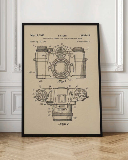 A framed vintage patent illustration from 1962 for a photographic camera with an exposure meter, showing detailed front and top-down technical drawings in black ink on aged beige paper. Decor