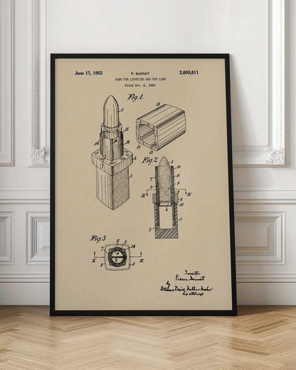 A framed vintage patent illustration for a lipstick case dated June 17, 1952. The schematic, printed in black ink on beige paper, displays various figures of the lipstick and its casing from different perspectives, including a cross-section. Print