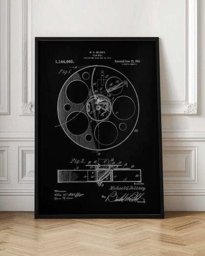 A framed black and white patent illustration for a film reel, invented by M. G. Delaney in 1912. The drawing, presented as a negative image with white lines on a black background, shows detailed schematics of the reel's mechanism from a top-down view (Fig. 1) and a cross-section (Fig. 2). Poster