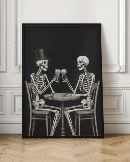 A vintage-style black and white illustration of two skeletons sitting at a round table, toasting each other with wine glasses. One skeleton wears a black top hat, and the background is solid black. Decor