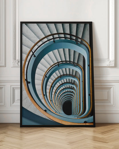 A high-angle, top-down photograph of a multi-story rectangular spiral staircase, creating a hypnotic, receding pattern. The steps are light gray marble, contrasted by shadows, and the balustrade is a striking light blue with a warm wooden handrail, leading down to a dark abyss at the center. Wall Art