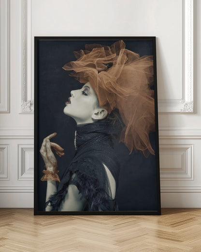 A dramatic profile portrait of a woman with pale skin against a black background, looking up. She wears an extravagant, voluminous orange tulle headpiece, a high-collared black feathered dress, and a matching orange glove. Poster