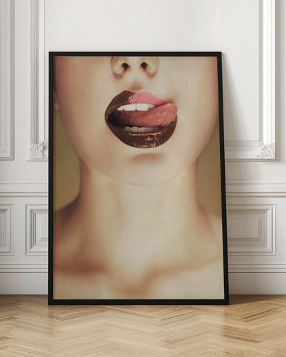 A close-up photograph of a woman's mouth with two-toned lipstick. The lips are mostly covered in glossy dark brown, with the upper right section in light pink. Her tongue is out, licking the pink part of her lip, revealing her white teeth. Print