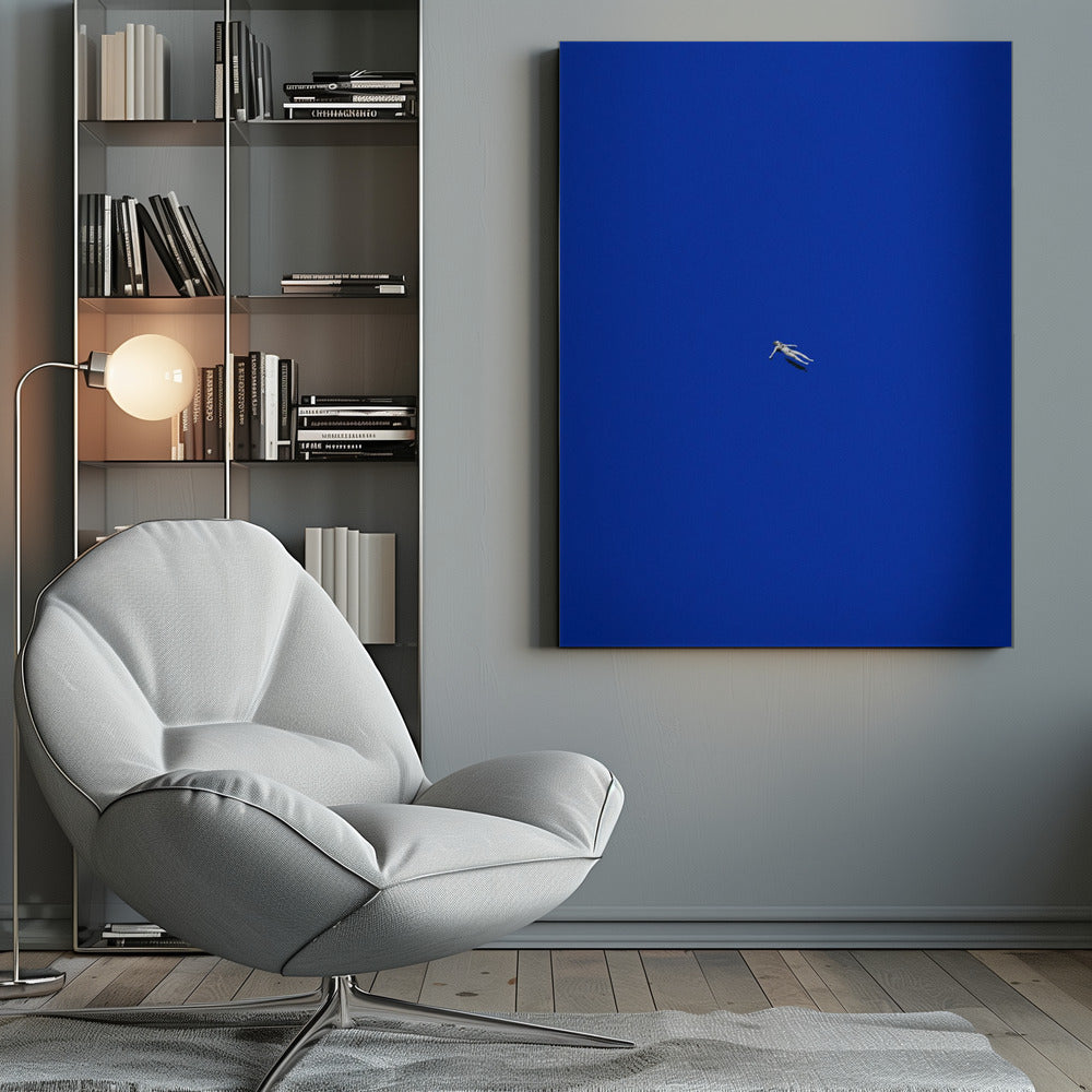 A minimalist and surreal artwork featuring a tiny, pale human figure floating peacefully in the center of an immense, solid, and vibrant blue void, all enclosed within a thin black frame. Wall Art