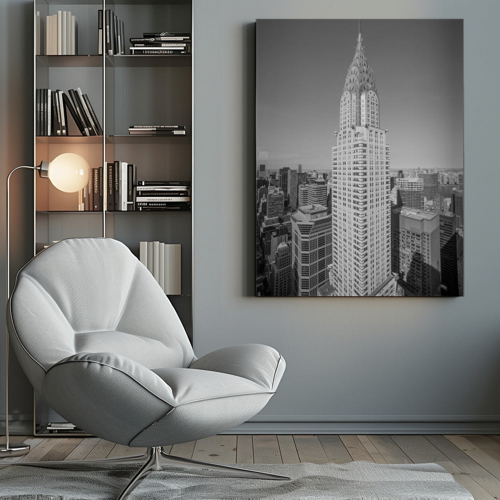 A high-angle, black and white photograph of the iconic Chrysler Building, its Art Deco spire prominently featured against the New York City skyline under a clear sky. Artwork