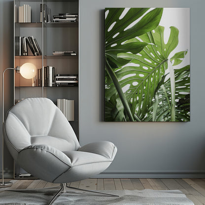 A low-angle, close-up photograph of vibrant green Monstera deliciosa leaves, showcasing their natural splits and holes against a bright white background, enclosed in a thin black frame. Print