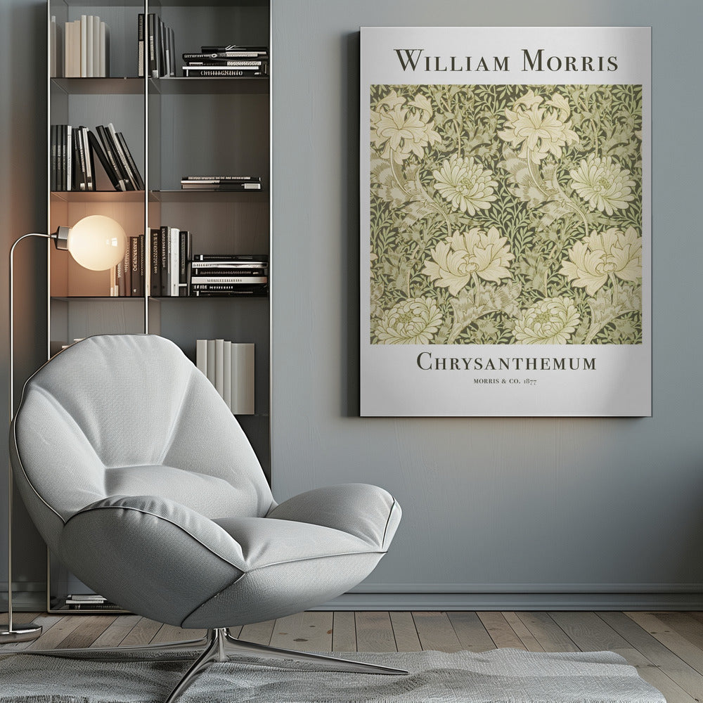 A framed art print of William Morris's 'Chrysanthemum' pattern from 1877. The design features a dense, repeating pattern of large, cream-colored chrysanthemums and foliage in shades of sage green on a dark green background. The poster has a white border with the artist's name at the top and the title at the bottom. Print