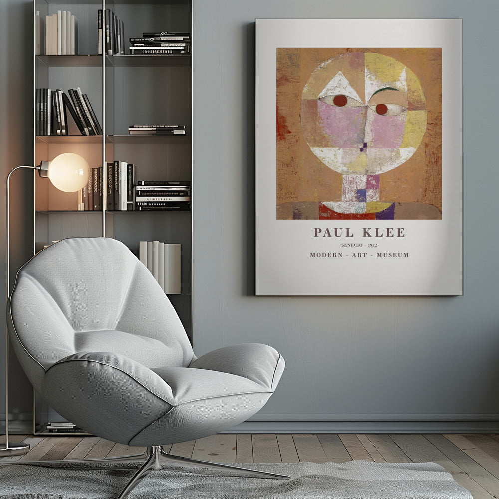 A framed museum poster of Paul Klee's 1922 painting 'Senecio'. The artwork is an abstract, geometric portrait of a human head in warm tones of orange, yellow, pink, and red against a textured brown background. The text 'PAUL KLEE', 'SENECIO - 1922', and 'MODERN - ART - MUSEUM' is printed below the image. Print