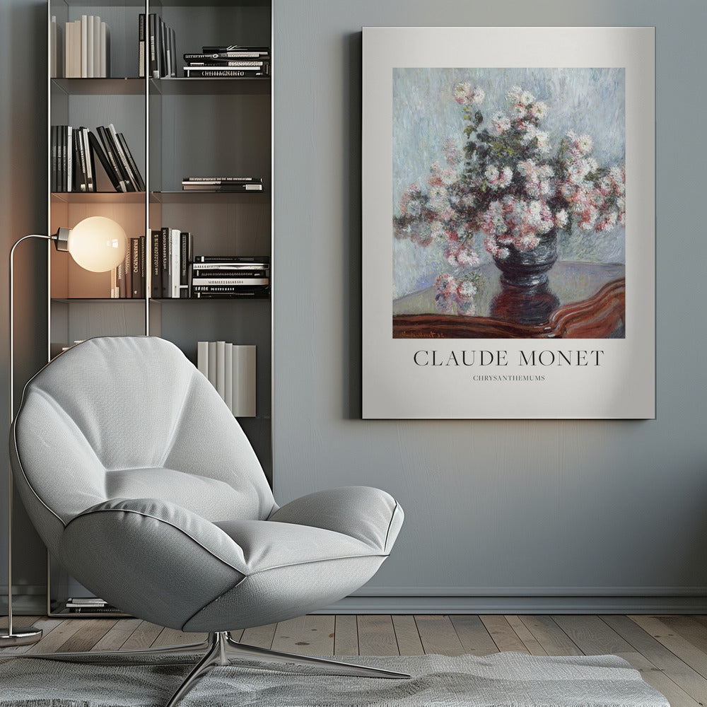 A framed art print of Claude Monet's impressionist painting, 'Chrysanthemums.' The painting features a lush bouquet of pink and white chrysanthemums in a dark vase resting on a reflective, mahogany-colored table against a light blue, textured background. The print includes a white border with the artist's name and the title below the artwork, all enclosed in a simple black frame. Print