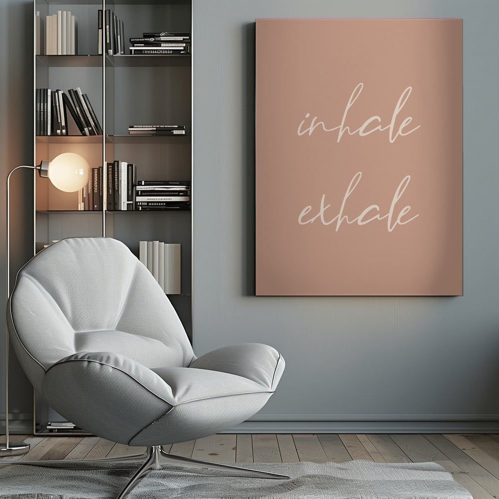 A minimalist framed poster featuring the words 'inhale' and 'exhale' in a flowing white script font, stacked vertically against a solid dusty pink background. Poster