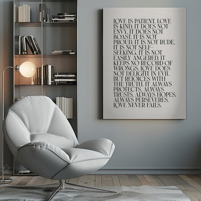 A minimalist art print featuring the 'Love is patient, love is kind...' bible verse from 1 Corinthians 13. The text is printed in a black, all-caps serif font on an off-white background and is surrounded by a simple black frame. Print